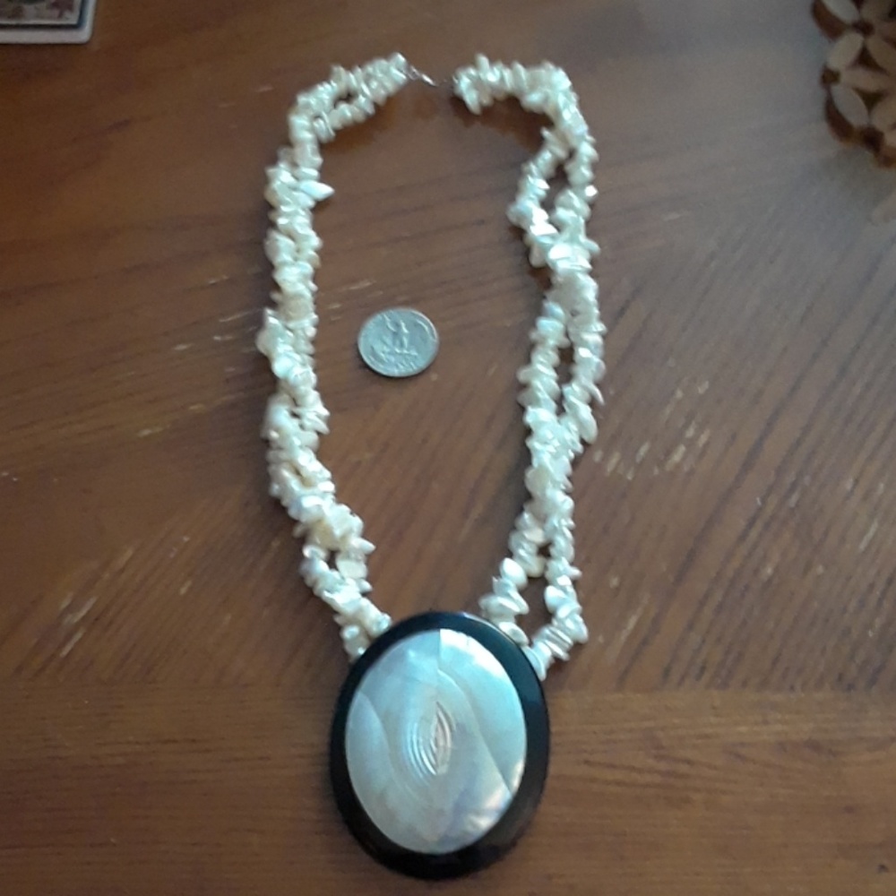Saltwater pearls with mother of pearl pendant.